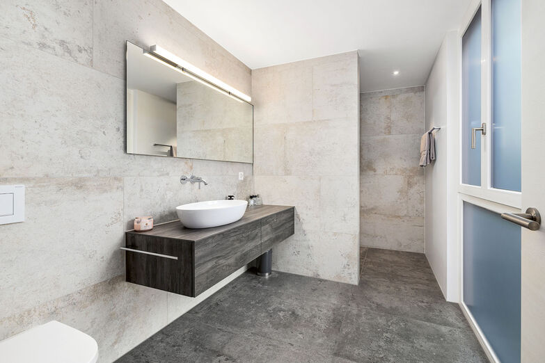 Hochwertige Materialien und eine klare Linienführung prägen das Badezimmer.