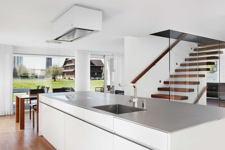 Küche, Ess- und Wohnbereich gruppieren sich um die zentral angelegte Treppe.